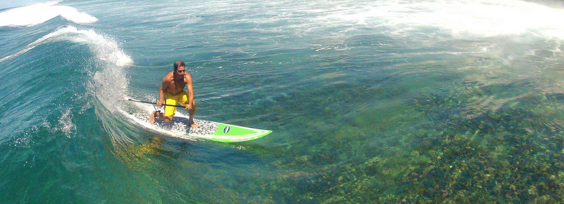 Stand up paddleboarding or SUP at the break in front of the Fiji Beachouse backpacker resort